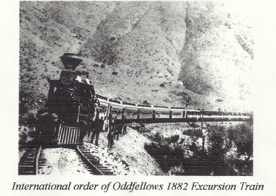 Locomotive on train tracks with people standing outside
